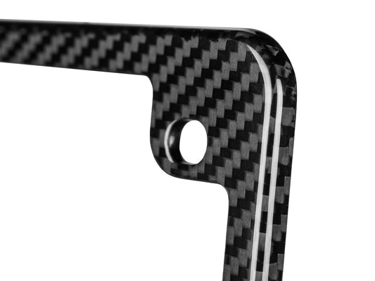 Close-up of high-gloss 3K twill carbon fiber motorcycle plate frame corner with mounting hole