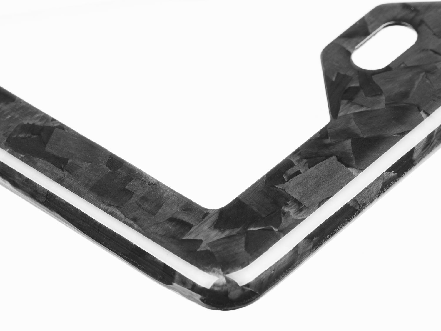 Close-up of forged carbon fiber texture showing high-gloss OEM clearcoat and marbled weave pattern