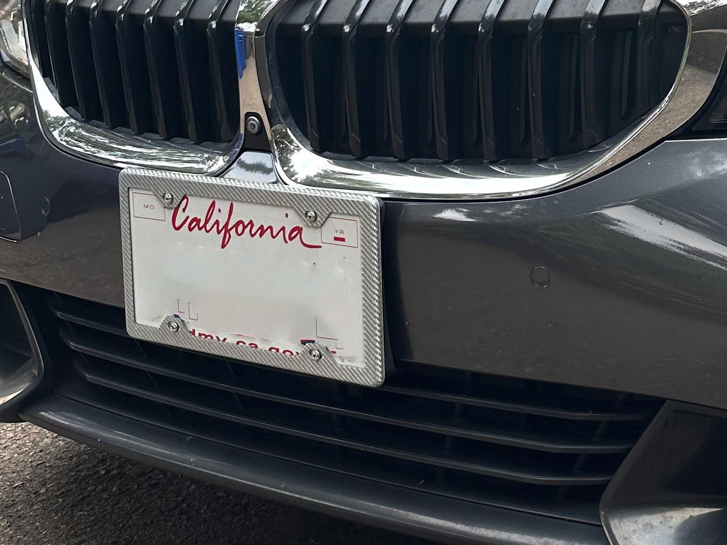 Silver carbon fiber frame on BMW